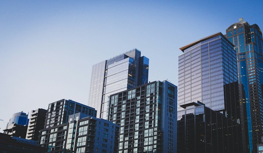 Glass condo towers against a blue evening sky